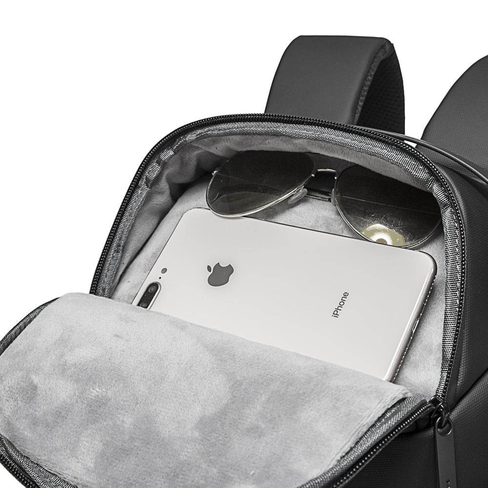 Bange 7277 Black Open backpack pocket showing a white smartphone and aviator sunglasses inside.
